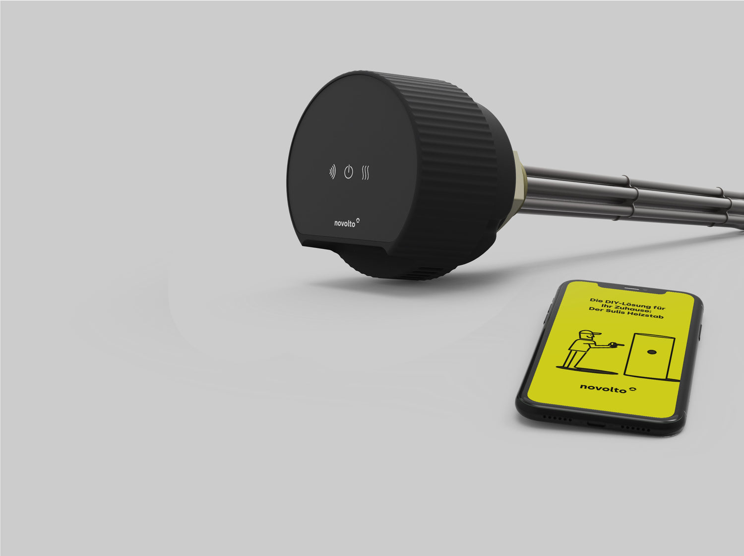 immersion heater and mobile phone with app lying on table 